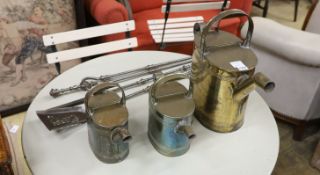 Three graduating brassed metal watering cans, largest height 40cm, together with a set of cast