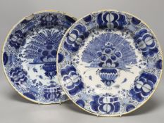 Two similar early 18th century Dutch Delft peacock pattern chargers,largest 33cms diameter.