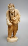 A Japanese ivory figure of a peasant farmer, Taisho/early Showa period, signed to a lacquer tablet -