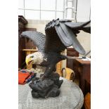 A large composition Golden Eagle garden ornament, height 90cm, width 165cm