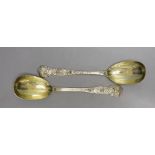 An ornate pair of Victorian silver gilt serving spoons, Lias & Lias, London,1874, 20.6cm, 6.4oz.