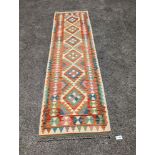 An Anatolian polychrome geometric flatweave Kilim runner, 290 x 84cm