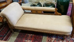 A late Victorian carved oak chaise longue upholstered in fawn suede, length 180cm, depth 70cm,