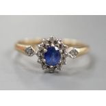 A modern 9ct gold, sapphire and diamond set cluster ring, size R, gross 2.3 grams.