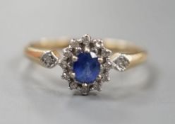 A modern 9ct gold, sapphire and diamond set cluster ring, size R, gross 2.3 grams.
