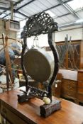 A Chinese carved hardwood gong on stand with beater, width 62cm, height 106cm