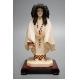 A Japanese ivory figure of a priest, Taisho/early Showa period, signed to a lacquer tablet - 17cm