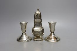 A modern pair of sterling mounted dwarf candlesticks, 92mm and a George V silver sugar caster, 16.