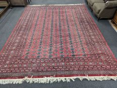 A Bokhara burgundy ground carpet, 360 x 276cm