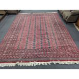 A Bokhara burgundy ground carpet, 360 x 276cm