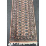 A Bokhara peach ground runner, 470 x 80cm