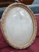 A Victorian oval gilt gesso display frame, width 66cm, height 80cm