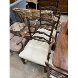 A set of eight Chippendale style mahogany dining chairs with pierced ladder backs, two with arms