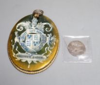 An Elizabeth I 1593 sixpence and a oval portrait frame the reverse depicting Elizabeth I coat of