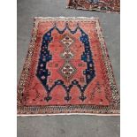 A Caucasian style blue ground geometric rug, 215 x 155cm