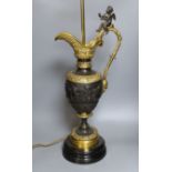 A large decorative bronze 'ewer' lamp with seated cherub - 75.5cm tall