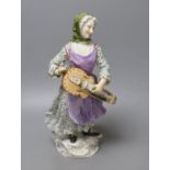 A large Meissen figure of a female hurdy gurdy player, 19th century - 33cm tall