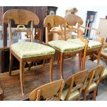 A set of eight Swedish Biedermeier birch with mahogany veneer, wreath design dining room chairs,