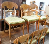 A set of eight Swedish Biedermeier birch with mahogany veneer, wreath design dining room chairs,