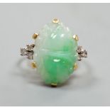 An 18ct, carved jade cabochon and diamond set oval dress ring, size O, gross weight 6.2 grams.