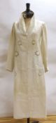 An Edwardian white/cream linen lady's coat with cut work detail and unusual button detail to the