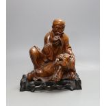 A Chinese wood group of a luohan - 21cm tall