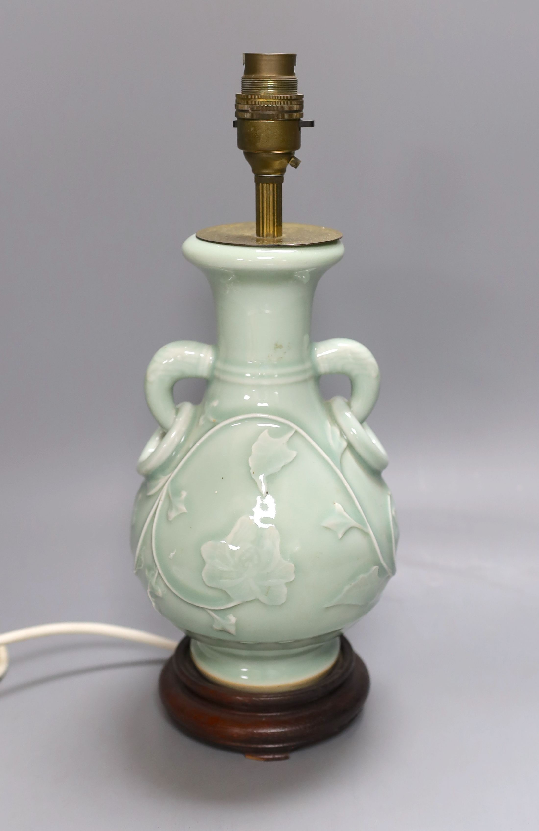 A Chinese celadon glazed two handled table lamp