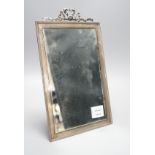 A George V silver mounted rectangular easel mirror, with ribbon bow crest, Stokes & Ireland Ltd,