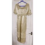 An Edwardian cream satin lady's dress with embroidered panels to base,sleeves front and collar