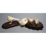 A Japanese Meiji period ivory bird with mother of pearl eyes, a Japanese group of three chickens and