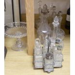 Sundry glassware including a six bottle cruet set on a plated stand, a Victorian cut glass jug, a