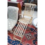 A weathered teak folding garden steamer chair