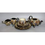 A Swiss Thoune treacle glazed incised pottery tea set, with coloured decoration (8)