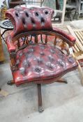 A reproduction Victorian style buttoned red leather upholstered swivel desk chair, width 63cm, depth