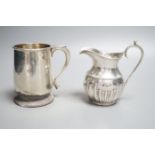 A late Victorian silver cream jug, Nathan & Hayes, Chester, 1897 and a George V silver christening