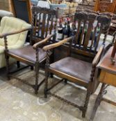 A pair of 1930’s carved beech Carolean style elbow chairs