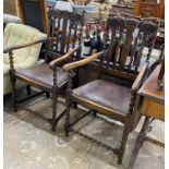 A pair of 1930’s carved beech Carolean style elbow chairs