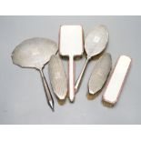 Two 1950's silver and enamel mounted brushes and an earlier four piece silver mounted brush set.