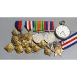 A group of four WW2 medals, together with a selection of cap badges and a pocket watch