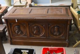 A 17th century style walnut cassone carved with busts in relief, width 160cm, depth 70cm, height