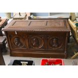 A 17th century style walnut cassone carved with busts in relief, width 160cm, depth 70cm, height