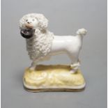 A rare Samuel Alcock porcelain figure of a standing poodle holding a hat in its mouth, c.1835-50,