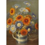 English School c.1910, oil on canvas, Still life of flowers in a Cornish ware jug, 50 x 36cm