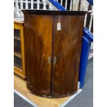 A George III mahogany bow front hanging corner cabinet, width 72cm, depth 50cm, height 102cm