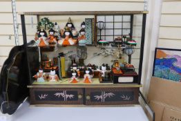 A 20th century Japanese diorama, (Hinamatsuri), depicting the Emperor's Court in an open cabinet,