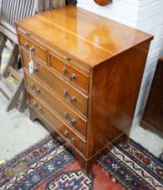 A small reproduction yew bachelor's chest of two short and three long drawers below brush slide,
