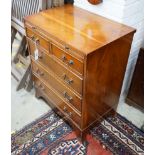 A small reproduction yew bachelor's chest of two short and three long drawers below brush slide,