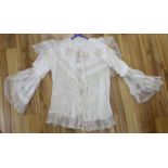 A fine cream silk and lace inserted pleated jacket