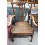 A large George III oak wood seat elbow chair, width 68cm, depth 47cm, height 112cm