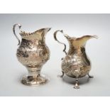 Two 18th century silver cream jugs, with later embossed decoration, London, 1753 & London, 1770,